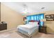 A bedroom with a bed, and bedside tables with lamps, illuminated by a ceiling fan at 2011 Wildcat Lake Ct, Lawrenceville, GA 30043