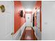 Inviting hallway with hardwood floors, contrasting wall colors and decorative artwork at 2011 Wildcat Lake Ct, Lawrenceville, GA 30043
