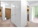 Hallway with neutral carpet leading to multiple rooms with closets and doorways at 2011 Wildcat Lake Ct, Lawrenceville, GA 30043
