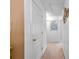 Hallway with neutral carpet and white doors, featuring attractive wall decor at 2011 Wildcat Lake Ct, Lawrenceville, GA 30043
