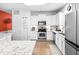 Bright white kitchen with stainless steel appliances, modern cabinets, and a breakfast area at 2011 Wildcat Lake Ct, Lawrenceville, GA 30043