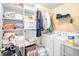 Laundry room with shelving, washer, and dryer for convenient chores at 2011 Wildcat Lake Ct, Lawrenceville, GA 30043