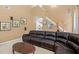 A cozy living room with a comfortable sectional sofa and a view into the kitchen at 2011 Wildcat Lake Ct, Lawrenceville, GA 30043