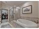 Modern bathroom featuring a soaking tub, walk-in glass shower, and walk-in closet at 3163 Neal Ct, Cumming, GA 30041