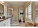 Bathroom featuring granite counters, walk-in shower and shuttered window at 3163 Neal Ct, Cumming, GA 30041