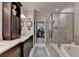 Luxurious bathroom featuring a double vanity, soaking tub, and glass-enclosed shower for a spa-like experience at 3163 Neal Ct, Cumming, GA 30041