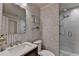 Well-appointed bathroom features a glass-enclosed shower, mirrored vanity, and stylish wallpaper at 3163 Neal Ct, Cumming, GA 30041