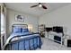 Cozy bedroom featuring large windows, ceiling fan, carpeted floors, and a bed with blue pillows at 3163 Neal Ct, Cumming, GA 30041
