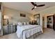 Comfortable bedroom with warm tones, a ceiling fan, and ample natural light creating a peaceful retreat at 3163 Neal Ct, Cumming, GA 30041