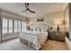 Tranquil bedroom with soft carpeting, ceiling fan, and shuttered windows for a bright and cozy ambiance at 3163 Neal Ct, Cumming, GA 30041