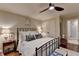 Comfortable bedroom with a ceiling fan and connecting ensuite bath/closet at 3163 Neal Ct, Cumming, GA 30041