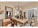 Stylish dining room with a long wooden table, modern chandelier, and ample seating at 3163 Neal Ct, Cumming, GA 30041