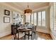 Elegant dining room featuring wainscoting, a chandelier, shutters, and a table set for a dinner party at 3163 Neal Ct, Cumming, GA 30041