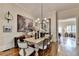 Spacious dining room with hardwood floors, a wooden table, and neutral decor at 3163 Neal Ct, Cumming, GA 30041