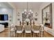 Well-lit dining room with hardwood floors, a wooden table, and views into the living area at 3163 Neal Ct, Cumming, GA 30041