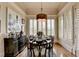 Charming dining room with a round table, ornate chairs, and a large window with plantation shutters at 3163 Neal Ct, Cumming, GA 30041