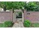 Inviting entrance with a brick wall, gate, and stone pathway to the front of the house at 3163 Neal Ct, Cumming, GA 30041