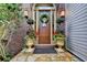 Inviting front entrance featuring a wreath, stone pathway, and decorative potted plants at 3163 Neal Ct, Cumming, GA 30041