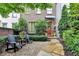 Charming brick townhome with a beautifully landscaped front yard and cozy seating area at 3163 Neal Ct, Cumming, GA 30041