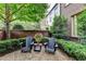 Relaxing front yard sitting area with Adirondack chairs and lush greenery, perfect for outdoor enjoyment at 3163 Neal Ct, Cumming, GA 30041
