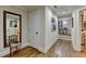 Bright hallway with hardwood floors, modern art, a striking mirror, and tasteful decorations at 3163 Neal Ct, Cumming, GA 30041