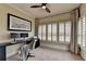 Bright home office with a built-in desk, dual monitors, and plantation shutters offering a functional workspace at 3163 Neal Ct, Cumming, GA 30041