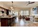 Open concept view of the kitchen and living room, hardwood floors, island and neutral color palette at 3163 Neal Ct, Cumming, GA 30041