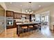 Kitchen with island, barstool seating, modern lighting, and stainless steel appliances at 3163 Neal Ct, Cumming, GA 30041