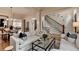 Elegant living room with white sofas, a glass coffee table and view into dining room at 3163 Neal Ct, Cumming, GA 30041