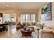 Bright living room featuring a comfortable sectional sofa, hardwood floors, and ample natural light through plantation shutters at 3163 Neal Ct, Cumming, GA 30041
