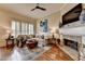 Inviting living room with a stone fireplace, plush seating, and a ceiling fan for added comfort at 3163 Neal Ct, Cumming, GA 30041
