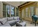 Relaxing outdoor patio with a comfortable sectional sofa, a grill, and privacy via window shutters at 3163 Neal Ct, Cumming, GA 30041