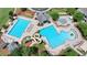 Aerial view of resort-style community pools with a waterslide and covered seating areas at 3163 Neal Ct, Cumming, GA 30041