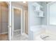 Bright bathroom features stand up shower, tiled tub, and decorative shelving at 3554 Cherry Blossom Court, Loganville, GA 30052