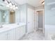 Bright bathroom features double sink vanity, marble floors, neutral paint, and updated lighting fixtures at 3554 Cherry Blossom Court, Loganville, GA 30052