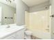 This bathroom features a large vanity with a sink, a toilet, and a shower over tub at 3554 Cherry Blossom Court, Loganville, GA 30052
