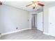 This bedroom features neutral-painted walls, light wood floors, a ceiling fan with lights and a white door at 3554 Cherry Blossom Court, Loganville, GA 30052