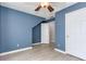 Bedroom features light-colored laminate floors, blue walls, and view into en suite bathroom at 3554 Cherry Blossom Court, Loganville, GA 30052
