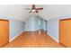 Bonus room with hardwood floors, neutral paint, window, and doors to the attic at 3554 Cherry Blossom Court, Loganville, GA 30052