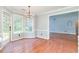 Sunny breakfast nook area featuring hardwood floors, large windows, and access to the kitchen at 3554 Cherry Blossom Court, Loganville, GA 30052