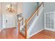 Inviting foyer with hardwood floors, a grand staircase, chandelier, and entry door with sidelight windows at 3554 Cherry Blossom Court, Loganville, GA 30052