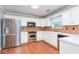 Well-lit kitchen with stainless steel appliances, white cabinets, and neutral backsplash at 3554 Cherry Blossom Court, Loganville, GA 30052