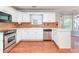 Spacious kitchen featuring stainless steel appliances, white cabinets, and ample counter space at 3554 Cherry Blossom Court, Loganville, GA 30052