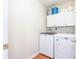 Functional laundry room with washer, dryer, and storage cabinets at 3554 Cherry Blossom Court, Loganville, GA 30052