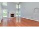 Bright living room with fireplace, vaulted ceilings, lots of natural light and gleaming hardwood floors at 3554 Cherry Blossom Court, Loganville, GA 30052