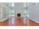 Bright living room featuring fireplace, soaring ceilings, lots of natural light and hardwood floors at 3554 Cherry Blossom Court, Loganville, GA 30052