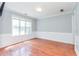 Bright living room with hardwood floors and a large window at 3554 Cherry Blossom Court, Loganville, GA 30052