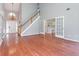 Bright, open living room featuring hardwood floors, high ceilings, and access to the kitchen through elegant French doors at 3554 Cherry Blossom Court, Loganville, GA 30052