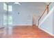Expansive living room with fireplace, hardwood floors, soaring ceilings, and arched entryways at 3554 Cherry Blossom Court, Loganville, GA 30052