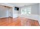 Inviting living room with hardwood floors, wainscoting, and a large window at 3554 Cherry Blossom Court, Loganville, GA 30052